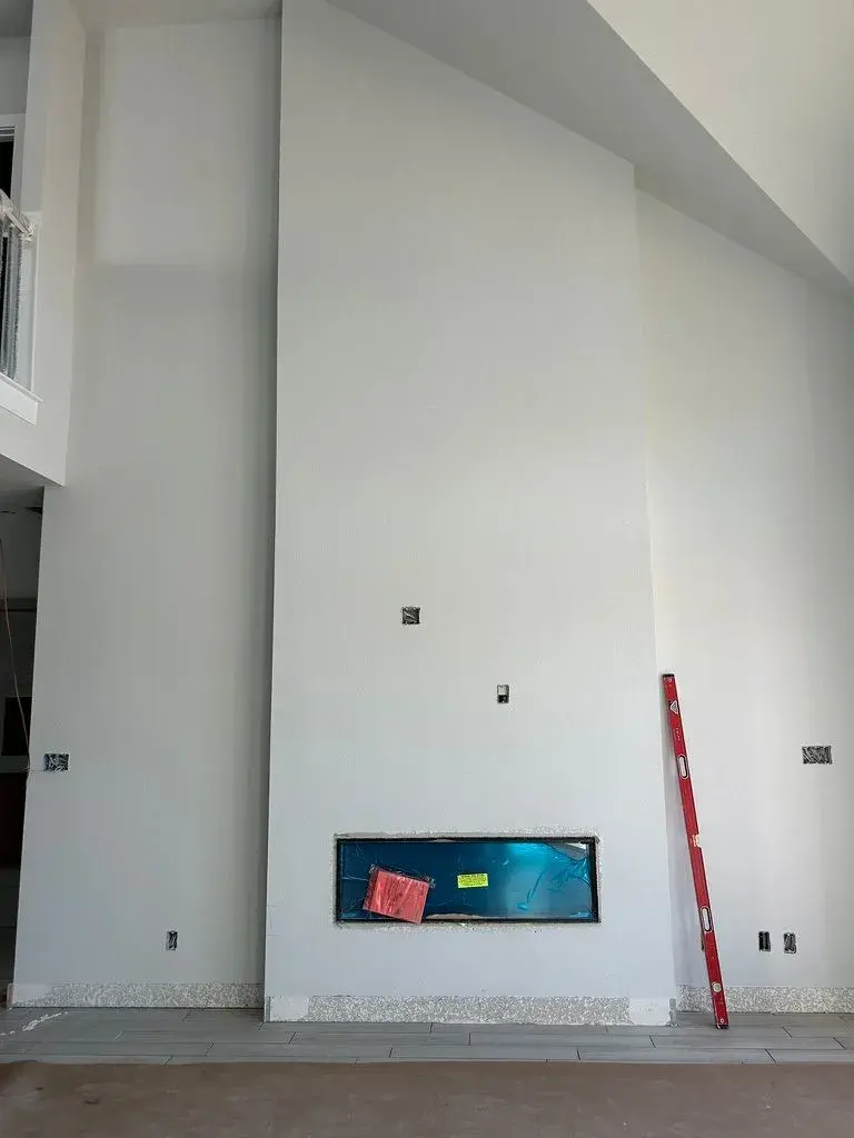 Floor-to-ceiling marble fireplace before remodel