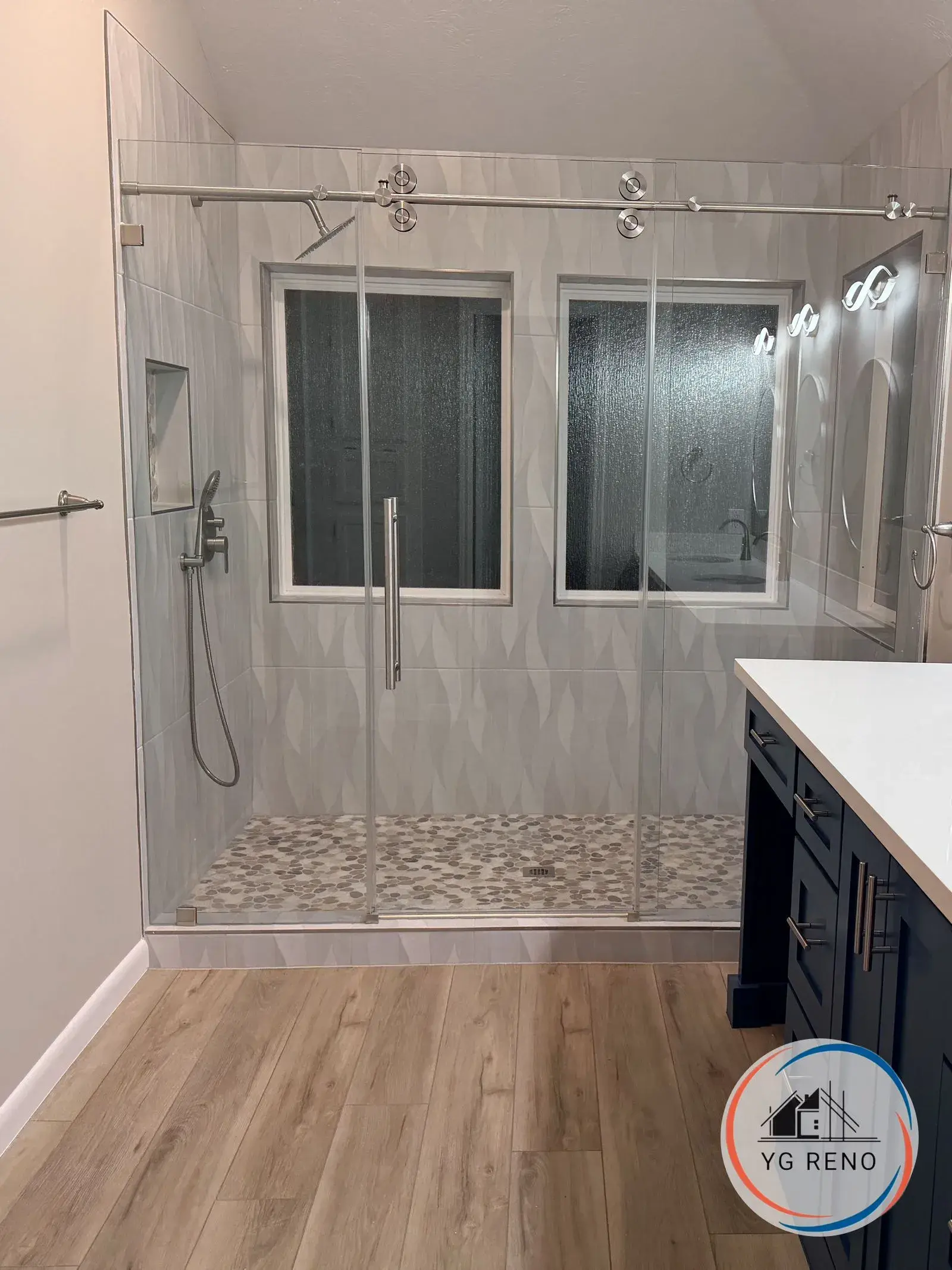 Corner shower and garden tub to frameless walk-in after remodel by YG Reno