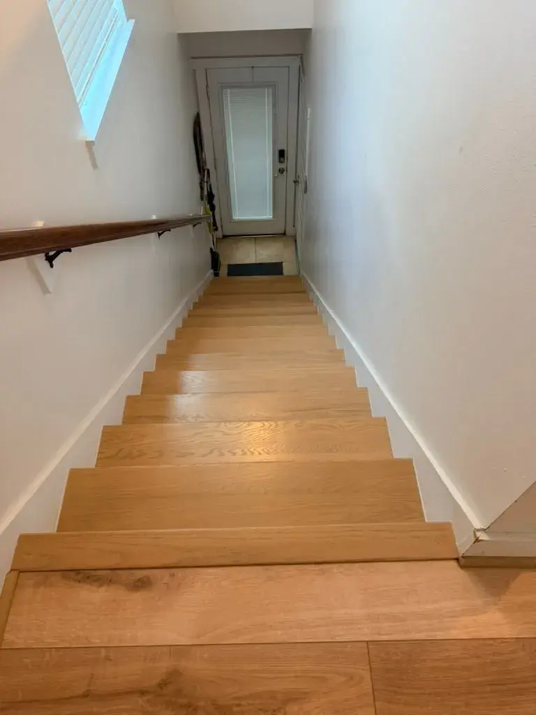 Carpeted stairs to white oak treads after remodel by YG Reno
