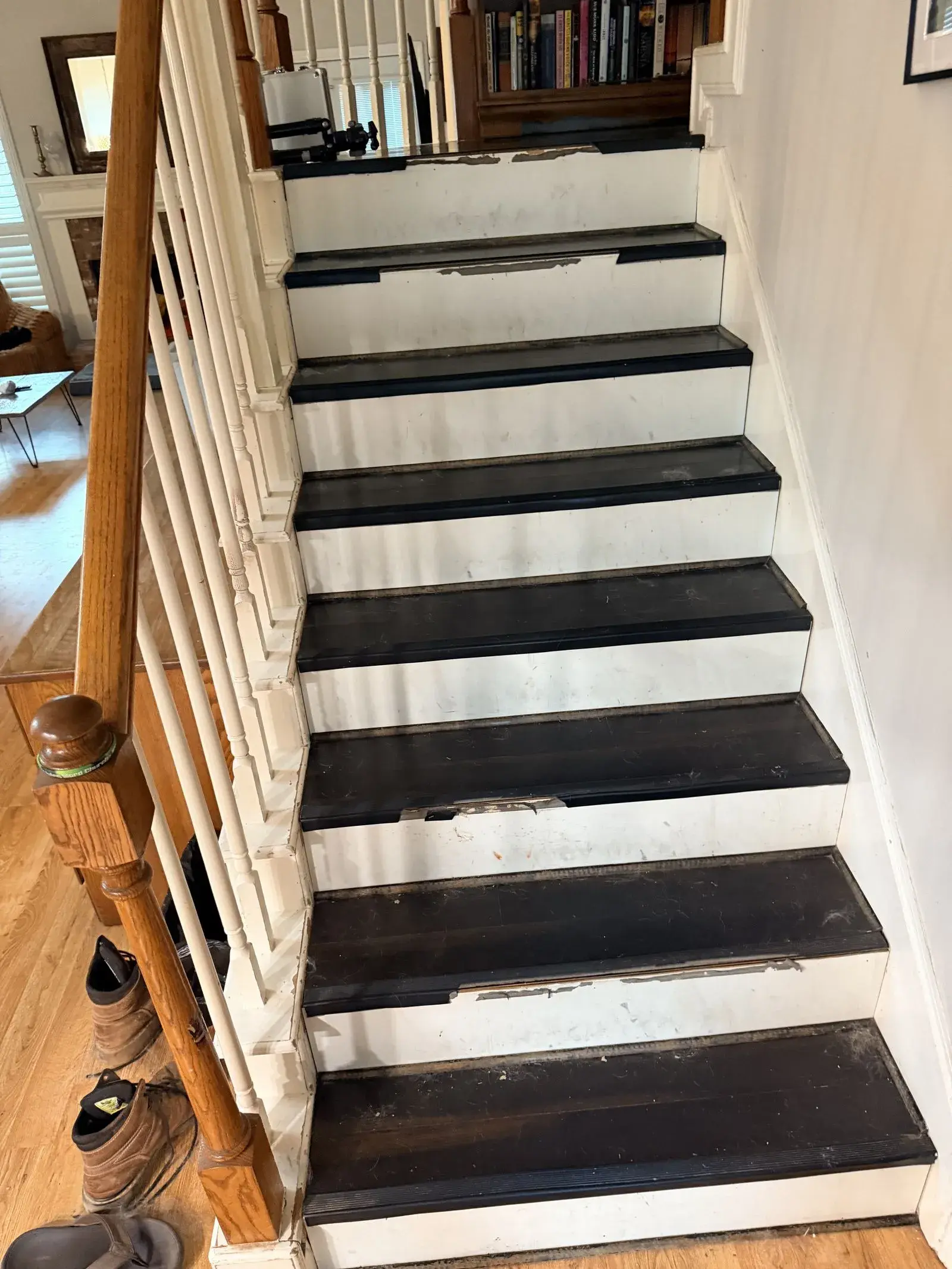 Painted stairs to oak treads and iron balusters before remodel
