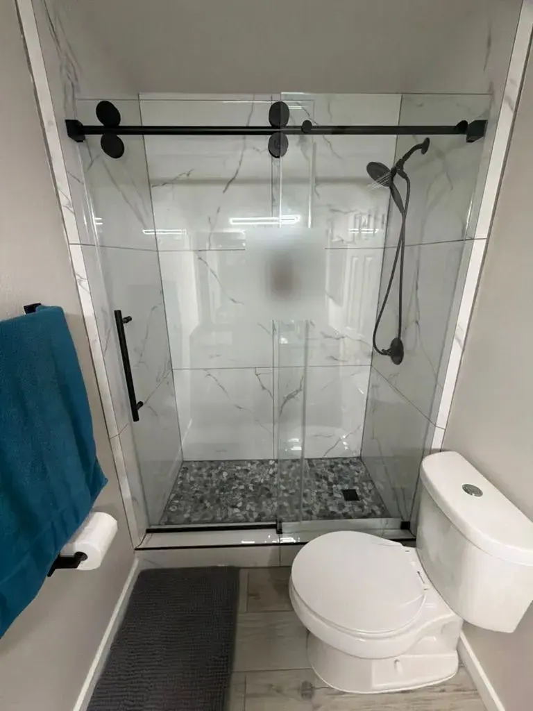 Marble walk-in shower with matte black hardware