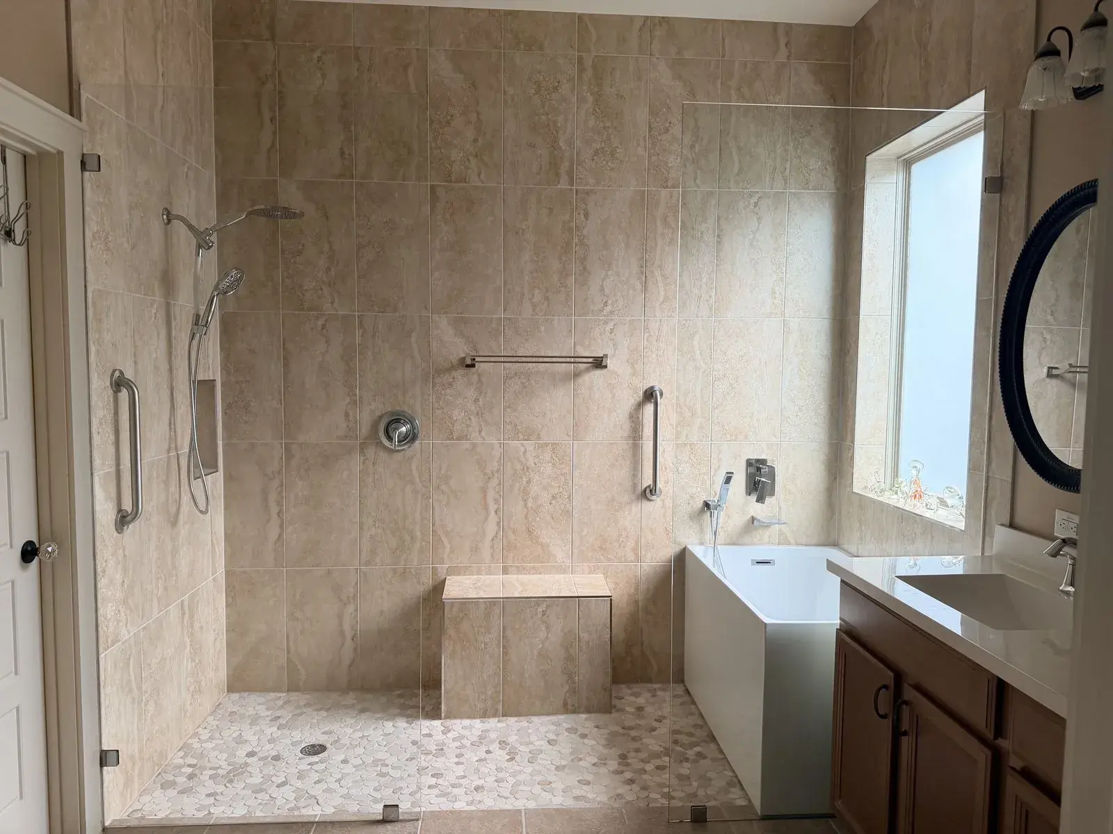 Full primary bath, walk-in shower and soaker tub after remodel by YG Reno